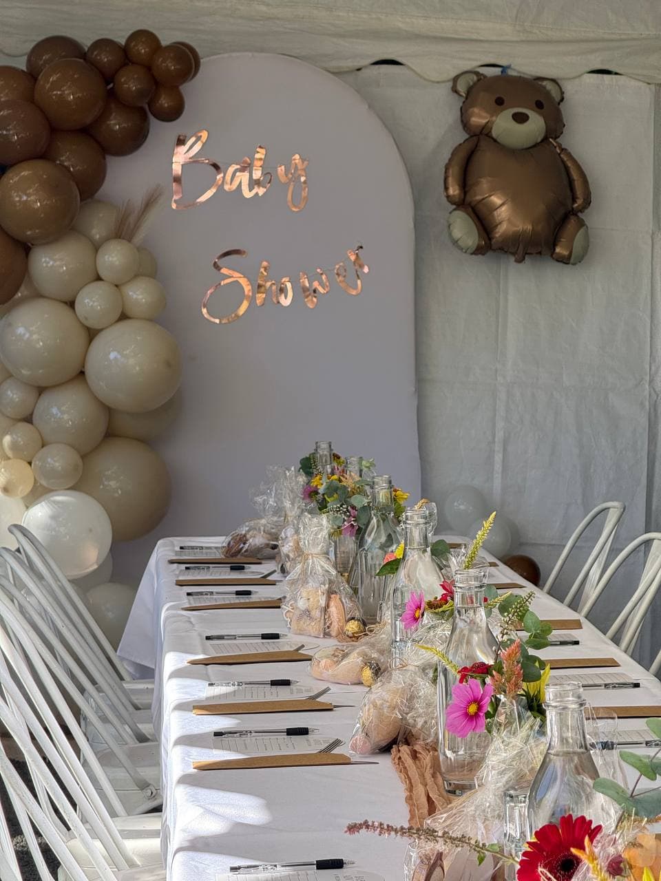 Outdoor baby shower on the Sunshine Coast — table with balloon arch and 'Baby Shower' backdrop at Fairhill, Ninderry
