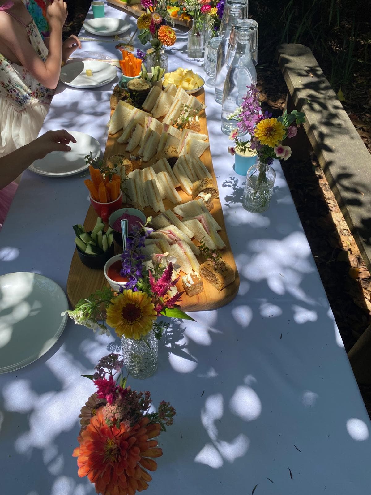 Baby shower decorations — tablecloths and fresh flower arrangements at Fairhill, Sunshine Coast