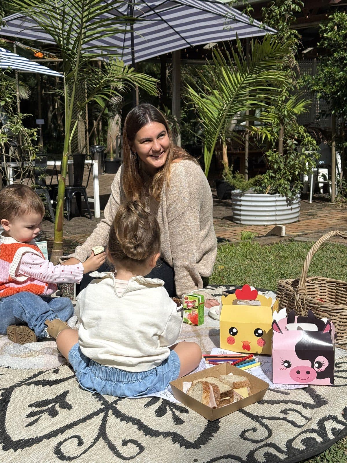 Party picnic with animal party boxes under the umbrellas in the gardens at Fairhill