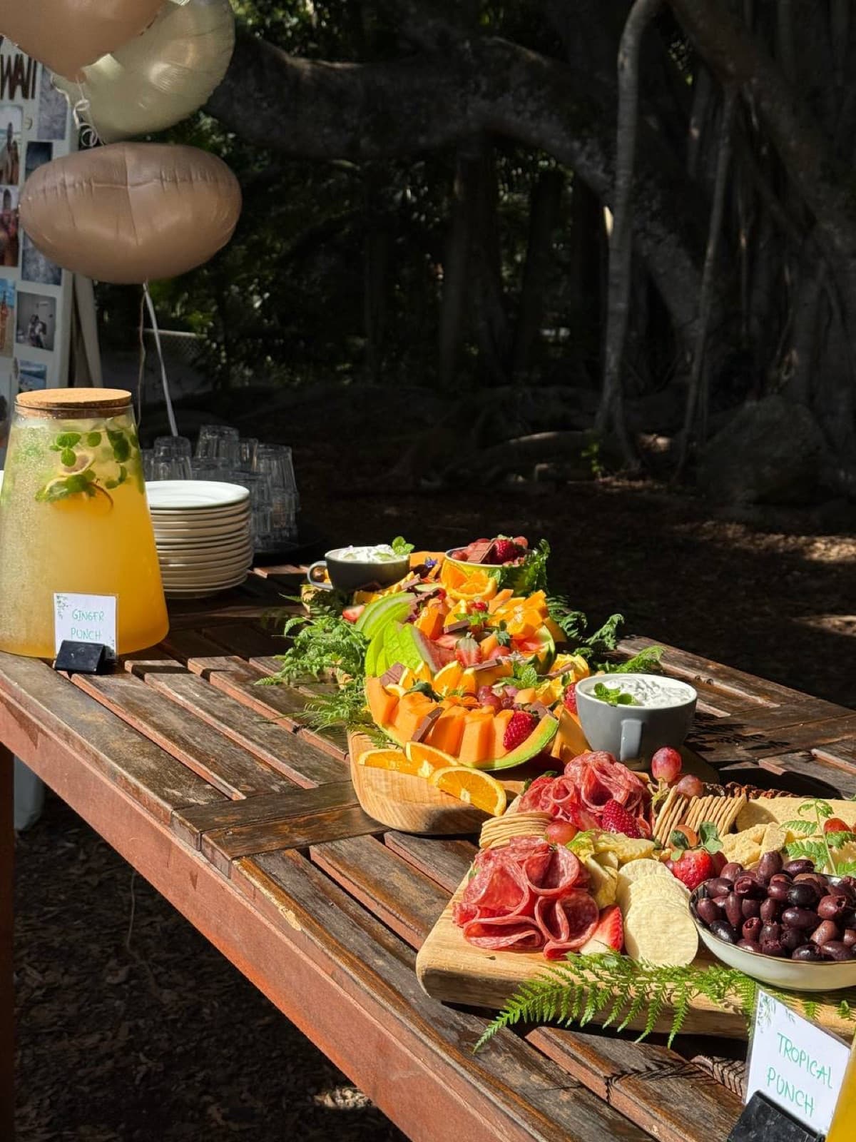 Grazing table and celebration spread beneath the trees