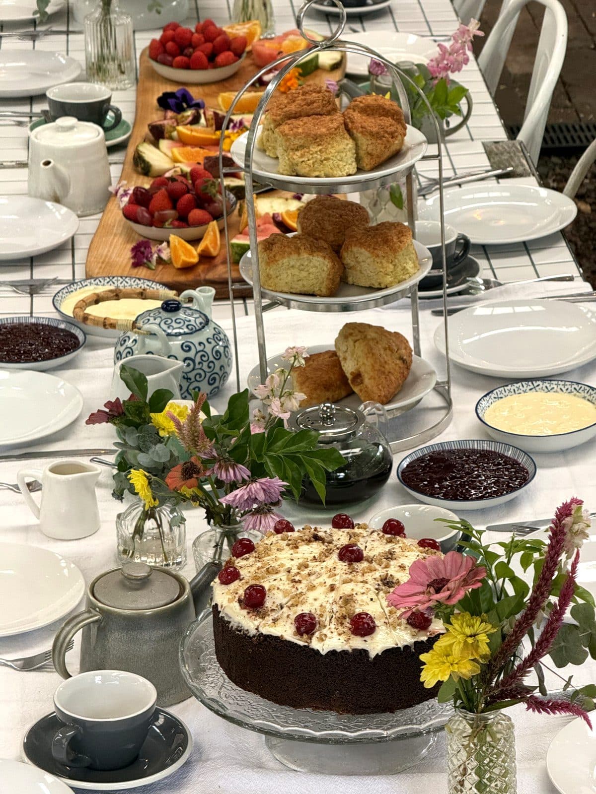 Cherry-topped cake, golden scones and a seasonal fruit grazing board with edible flowers at the Bush Harvest Morning Tea