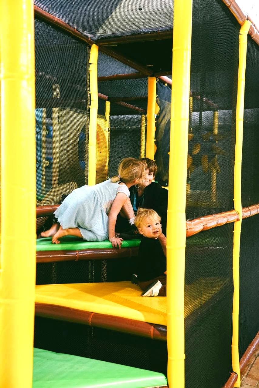 Children tumbling and laughing on the padded levels of Little Sprouts indoor playground on the Sunshine Coast