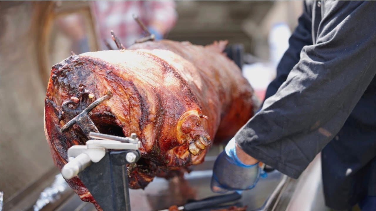 Our Carver working the crackling on a whole spit pig at Fairhill