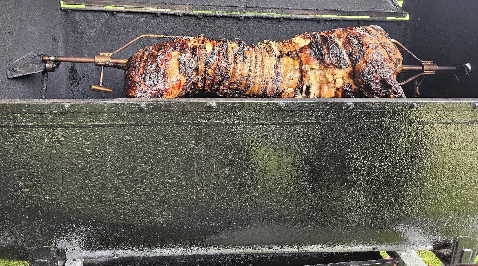 Spit roast turning over the coals