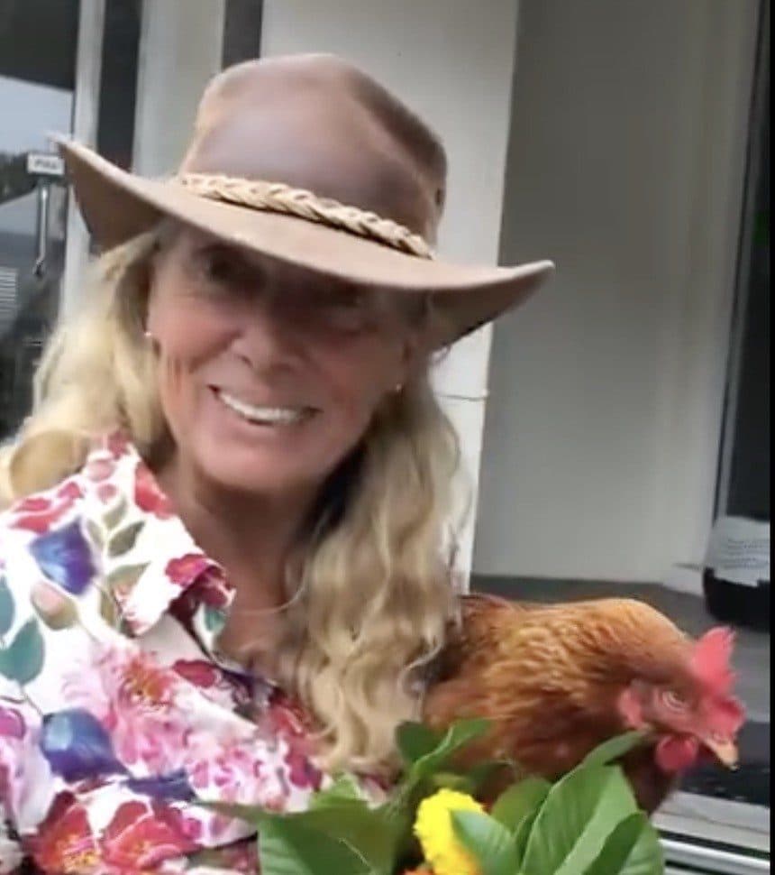 Angela Wright, Fairhill owner, holding one of our hens outside the Country Store