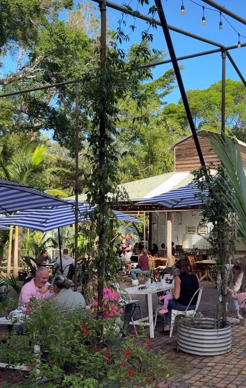 Guests enjoying lunch at the Gardens Cafe under the trees at Fairhill