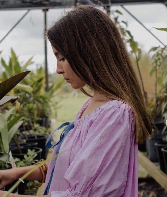 A Fairhill nursery teammate working among the plants in the greenhouse
