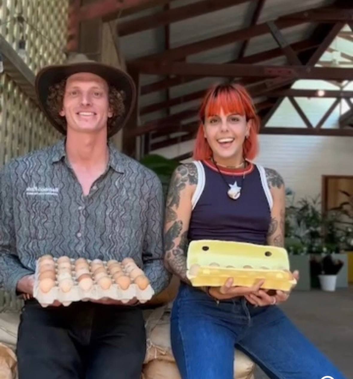 Two Fairhill teammates holding trays of fresh eggs from our hens, Sunshine Coast
