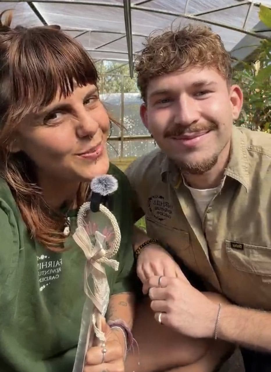 Two Fairhill teammates in uniform in the nursery greenhouse